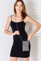 Model wearing black dress with Chaos Spark Mini Bag crossbody, rhinestone sparkle evening bag with chain strap