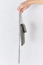 Side view of Chaos Spark Mini Rhinestone Crossbody Bag with silver chain strap held in hand