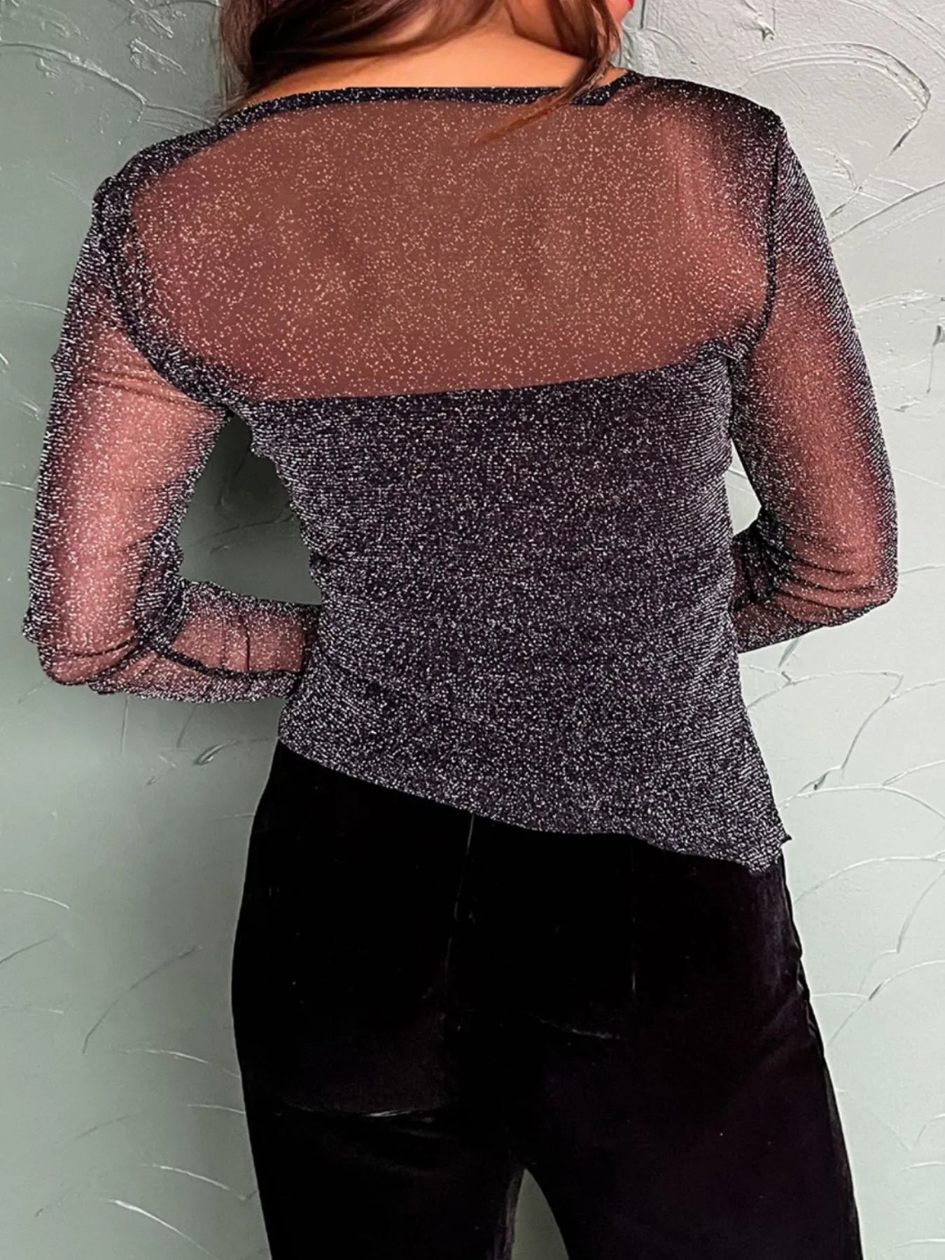 Back view of the Metallic Glitter Mesh Long Sleeve Top showing sheer glitter mesh design.