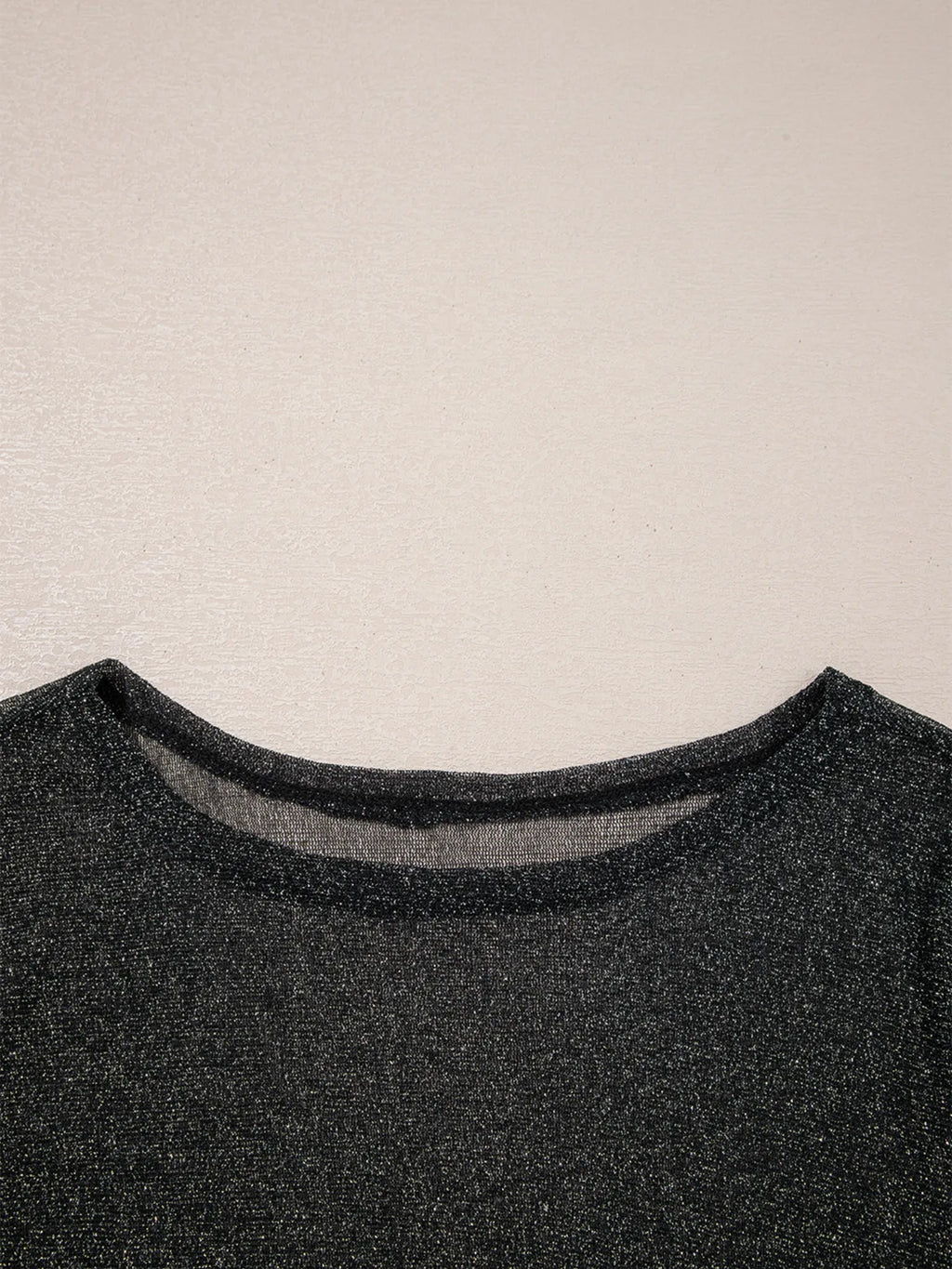 Close-up of the neckline on the Metallic Glitter Mesh Long Sleeve Top showing the sheer glitter fabric.