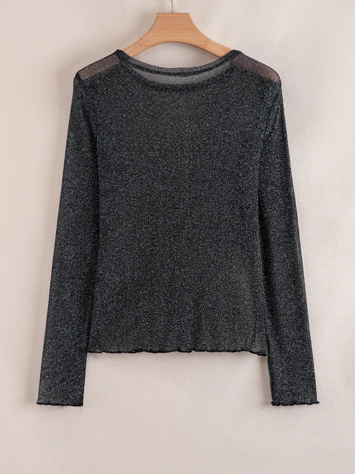 Flat lay of the Metallic Glitter Mesh Long Sleeve Top in black glitter mesh with long sleeves.